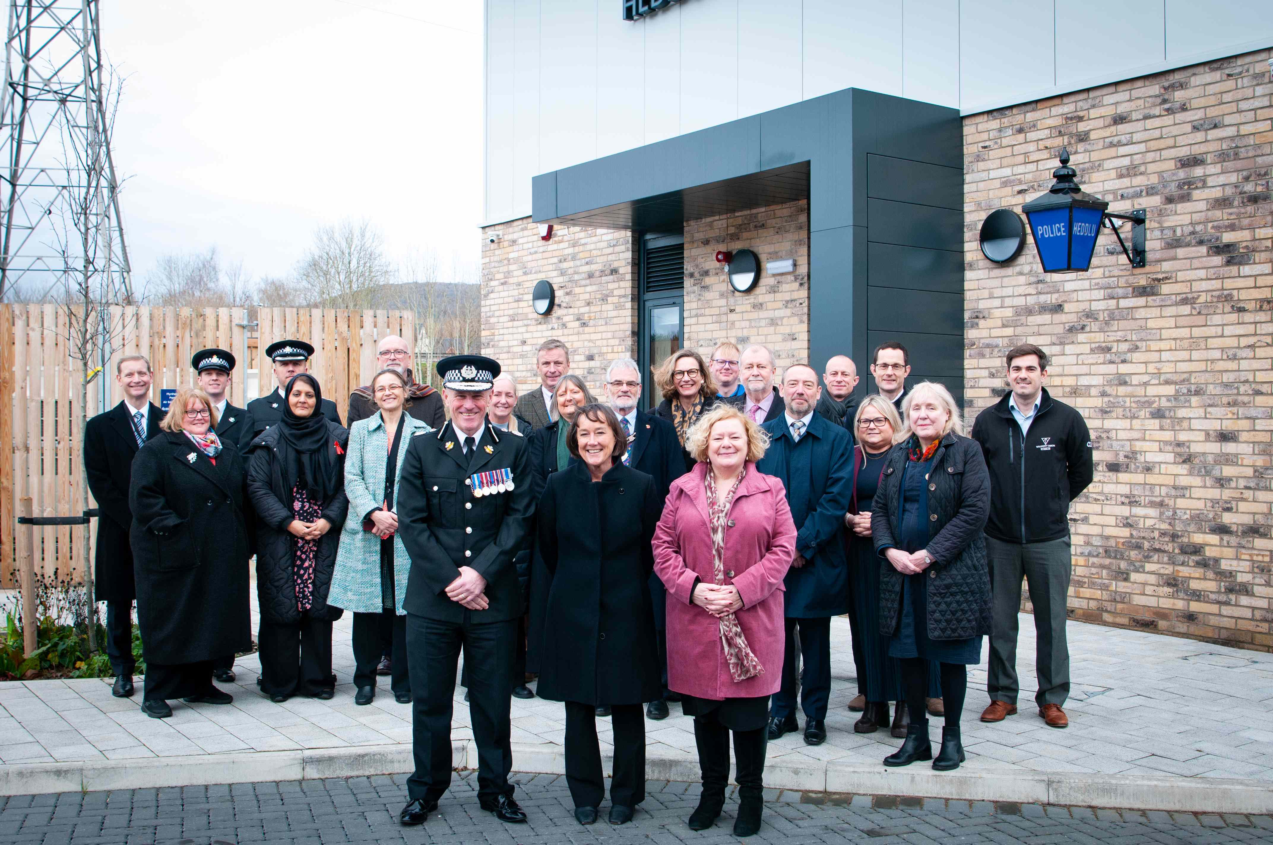 Group of people standing in front of the entrance to the police station.
