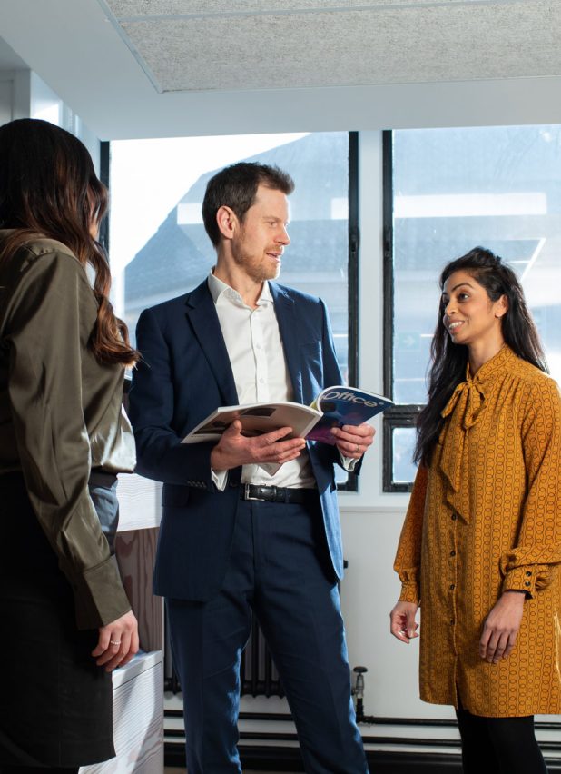 People in an office stood talking