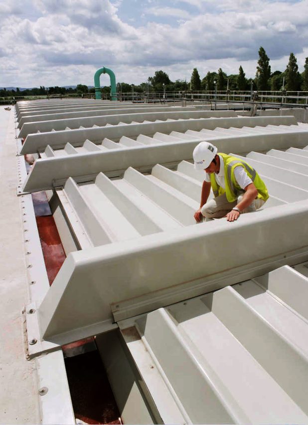 Person working wearing a hard hat a water treatment plant