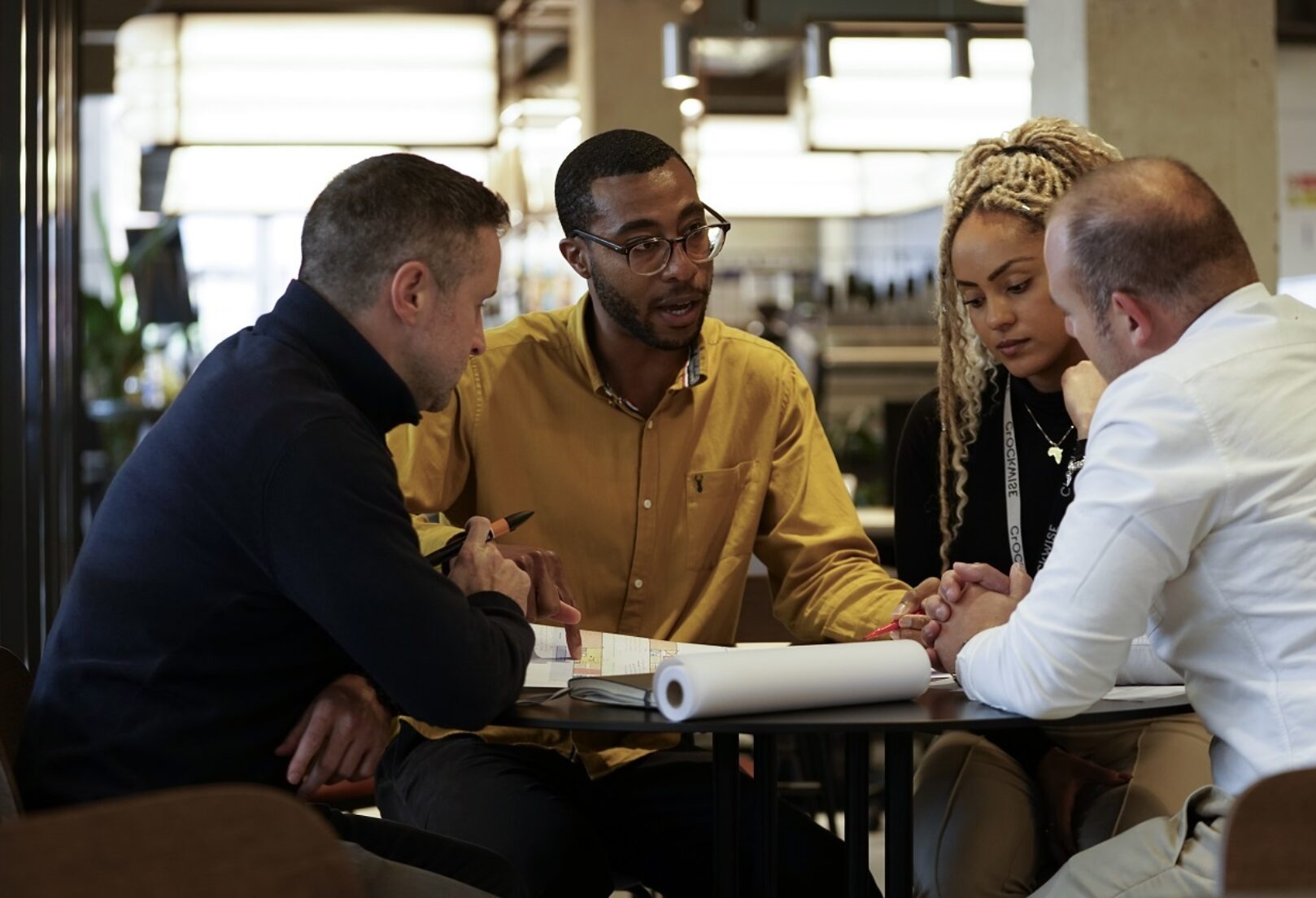 Image of four people looking at plans