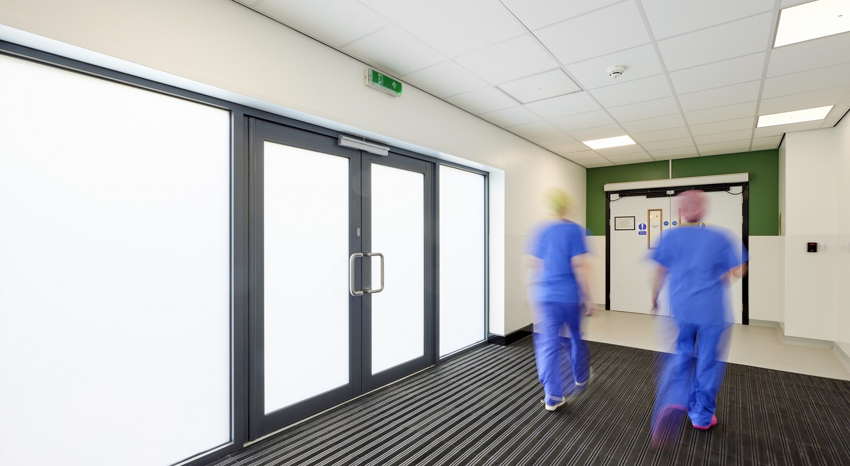 Hospital staff walking through corridor