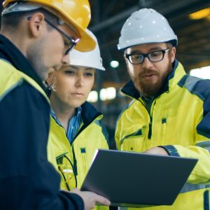 People wearing hard hats looking at a document