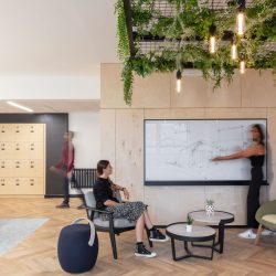 People looking a whiteboard in a modern office