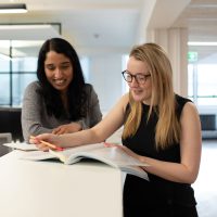 Two people looking a document