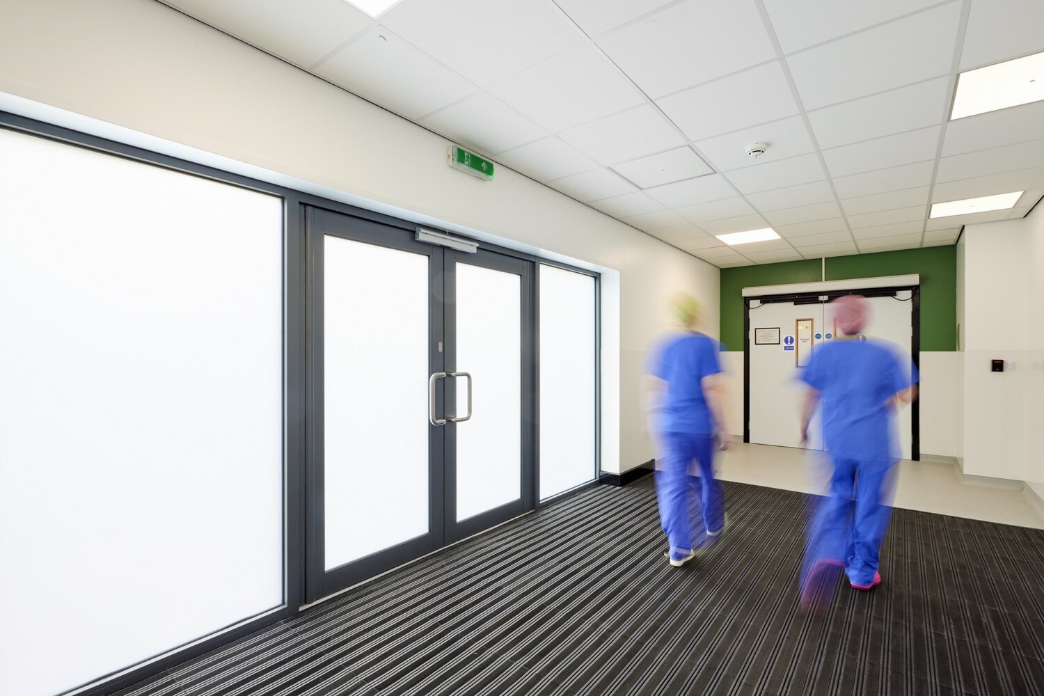 Hospital staff walking through corridor
