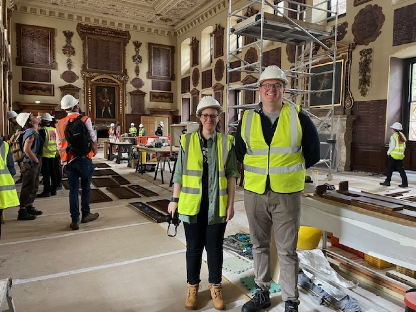 Neli and Ed standing side by side wearing hard hats and high vis vests