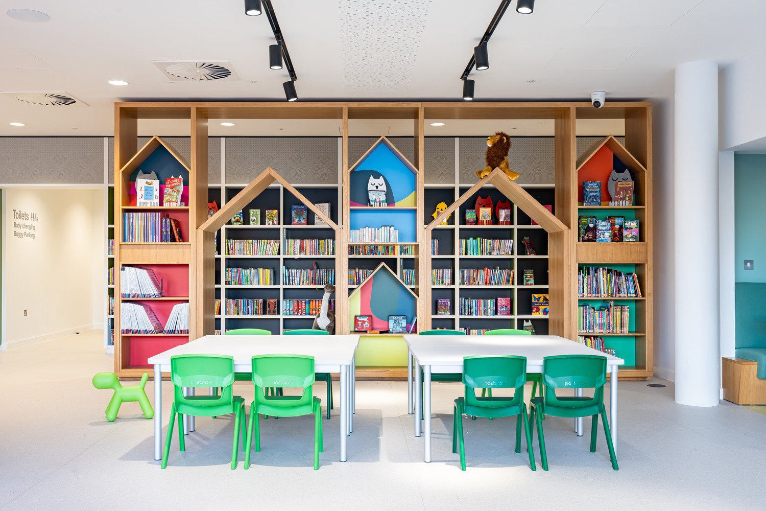 Children's library section with house-shaped shelves