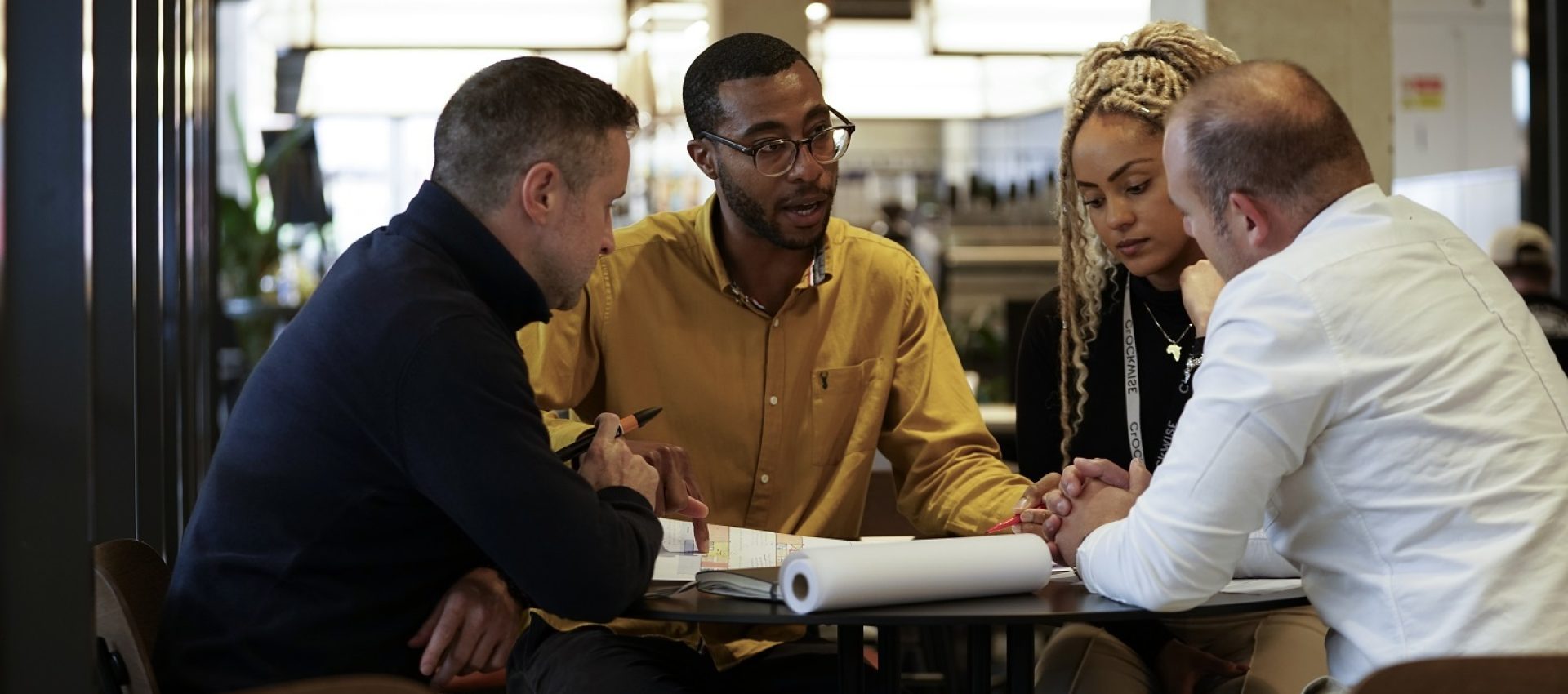 Image of four people looking at plans