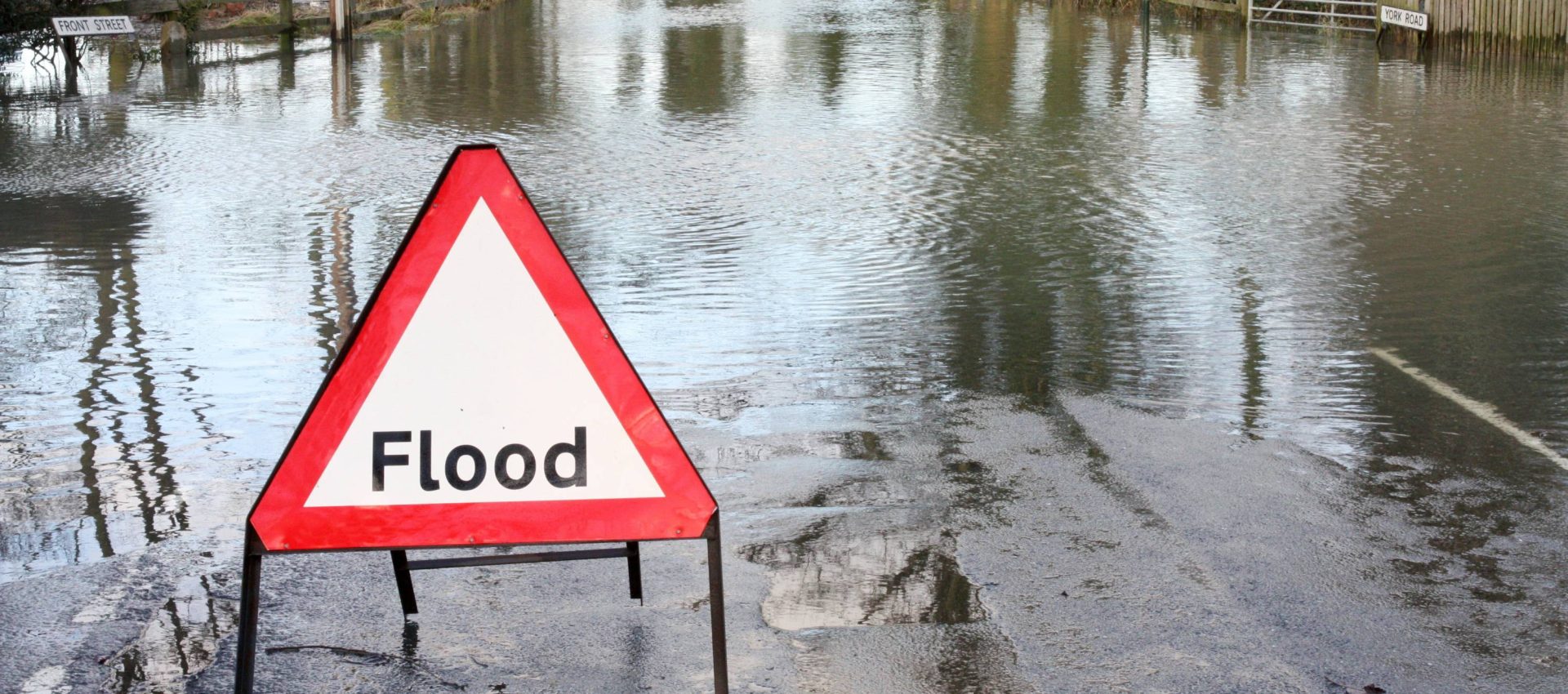Flooding surrounded by flood sign