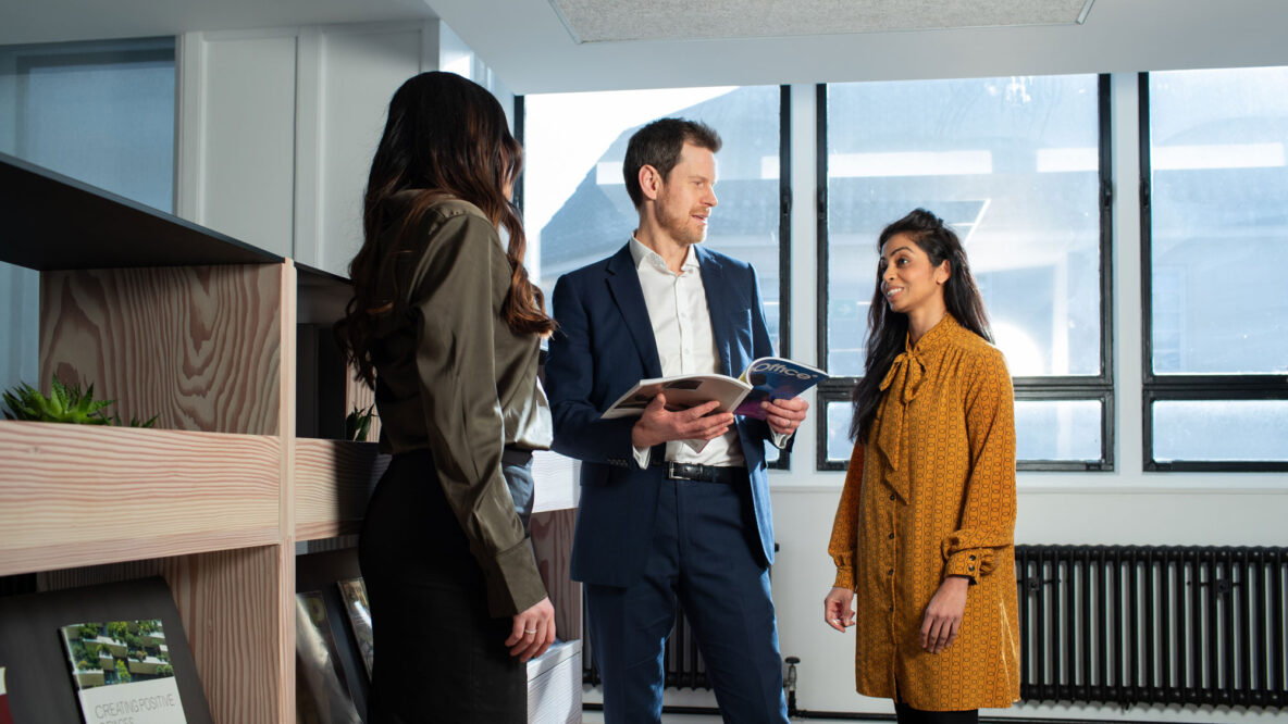 People in an office stood talking