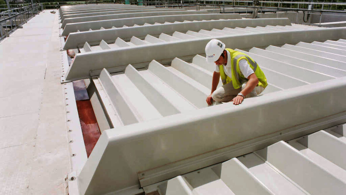 Person working wearing a hard hat a water treatment plant