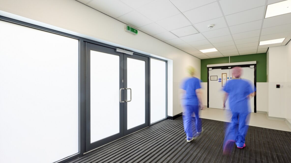 Hospital staff walking through corridor