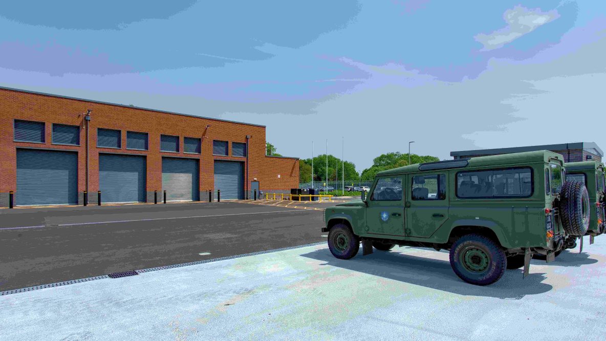 Outside shot of the garage with army truck infront