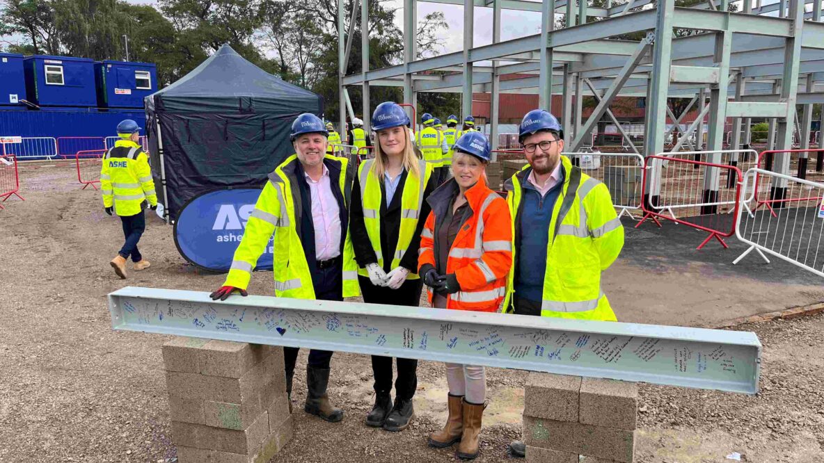 Project Management team stood behind a block of steel