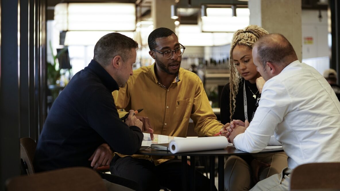 Image of four people looking at plans
