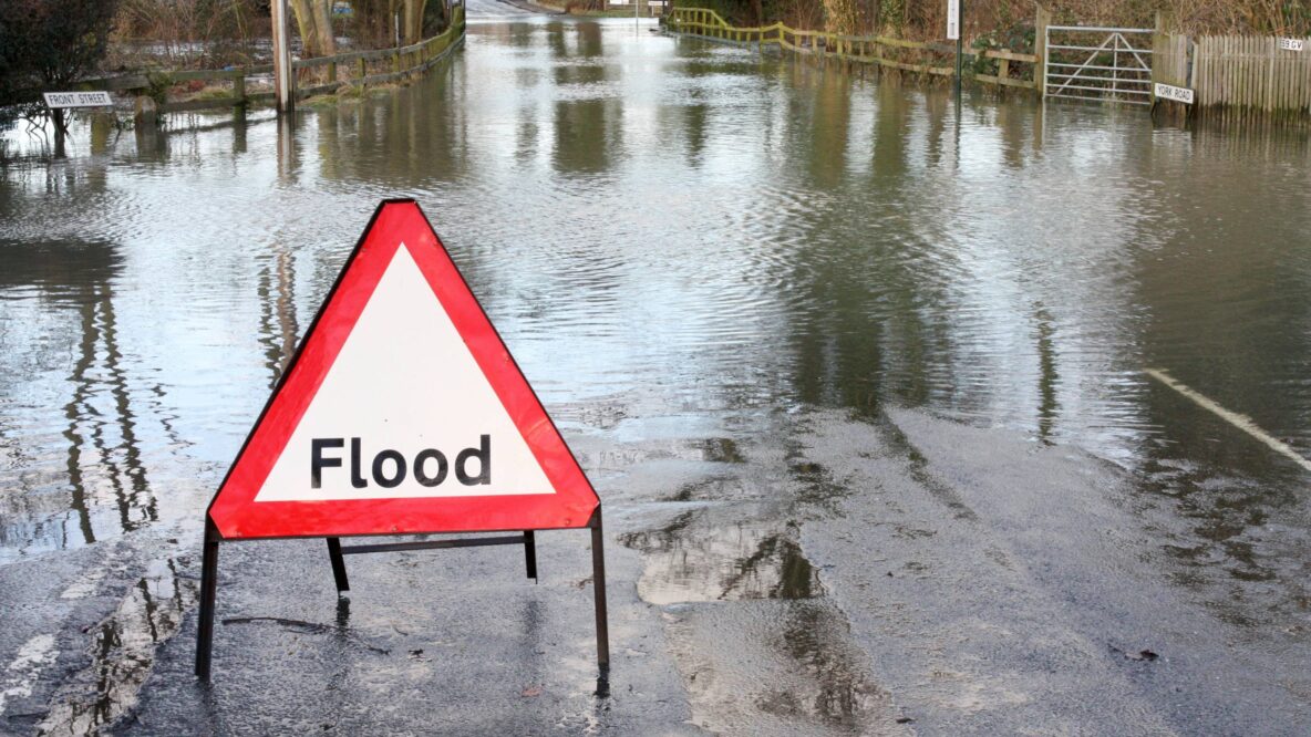 Flooding surrounded by flood sign