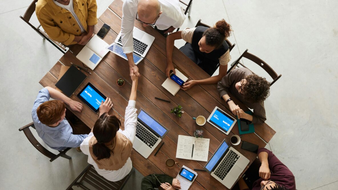 Image of peopl around a table having a meeting