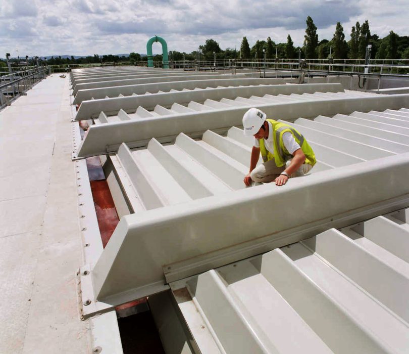 Person working wearing a hard hat a water treatment plant