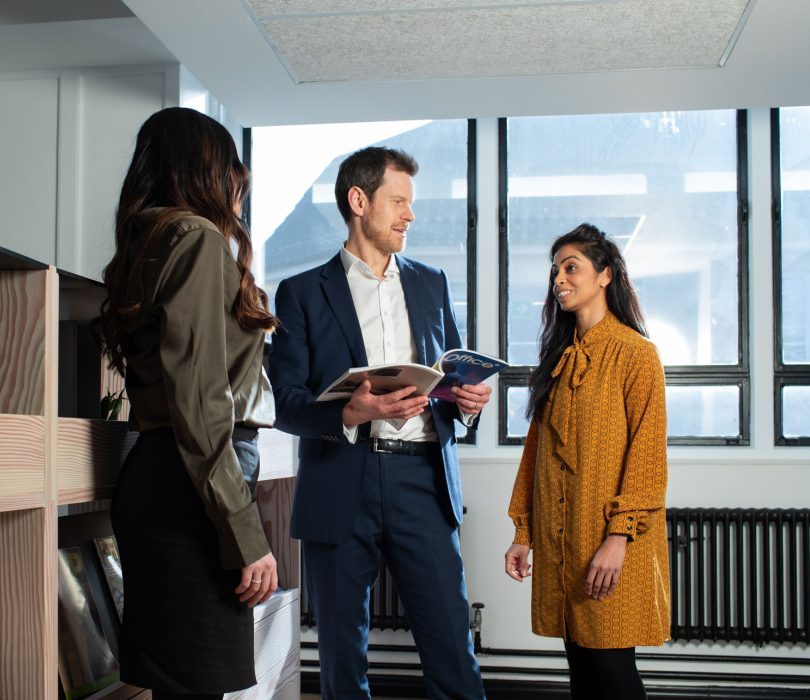 People in an office stood talking