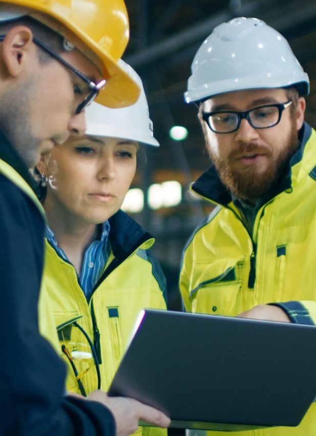People wearing hard hats looking at a document