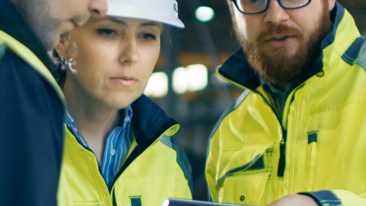 People wearing hard hats looking at a document