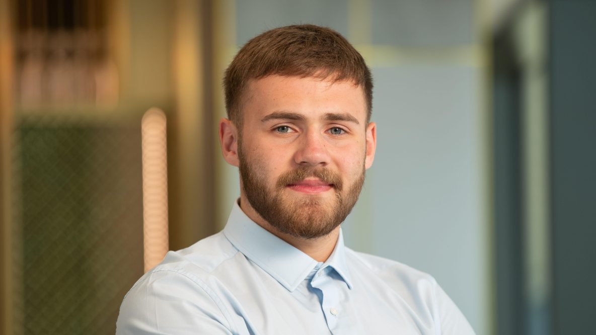 Man smiling at camera in modern office