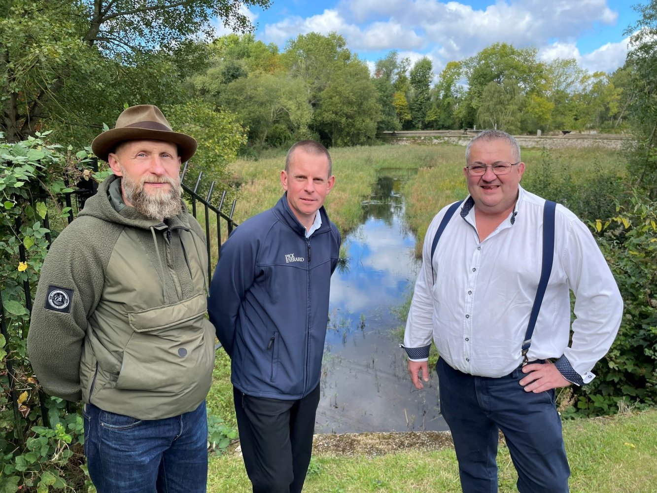 Paul Cannaby, director of civil engineering standing infront of one of the filter beds with two members of the project team.