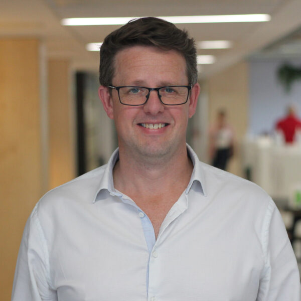 Richard in a shirt posing in the office