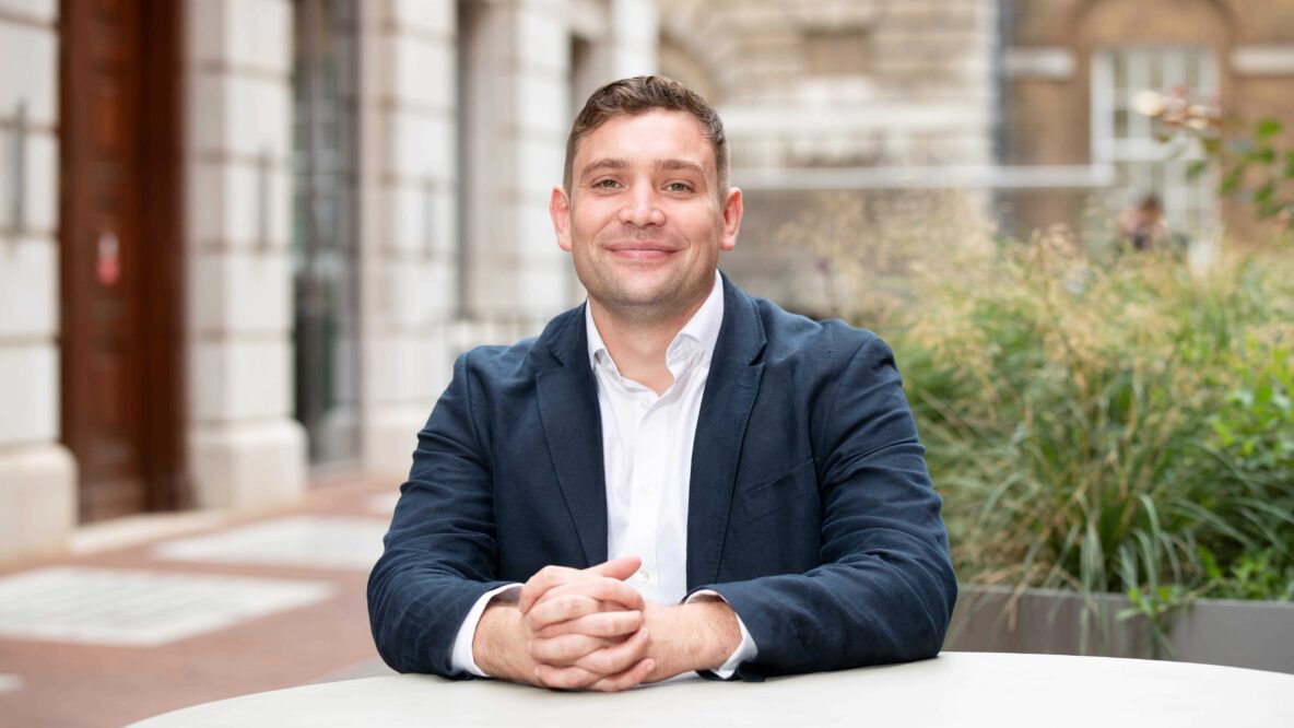 Matthew Appleton sitting at a roundtable smiling