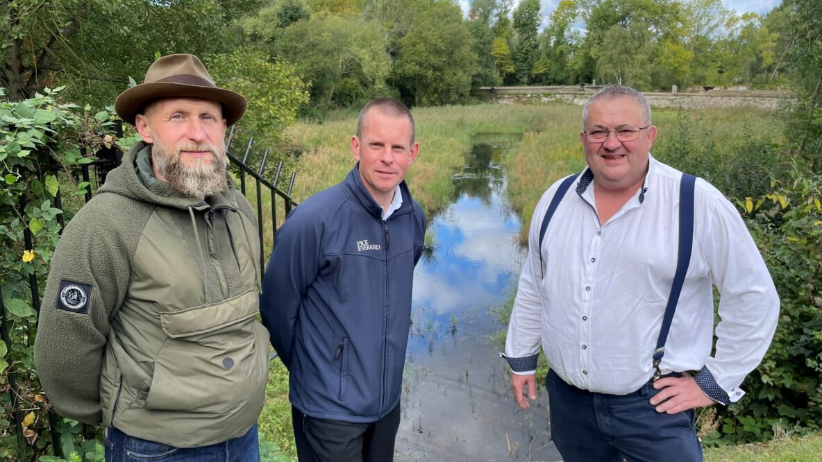 Paul Cannaby, director of civil engineering standing infront of one of the filter beds with two members of the project team.