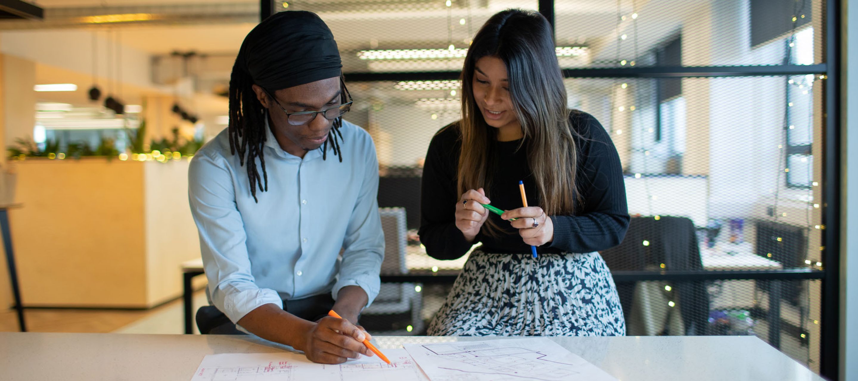 Two people looking at a drawing