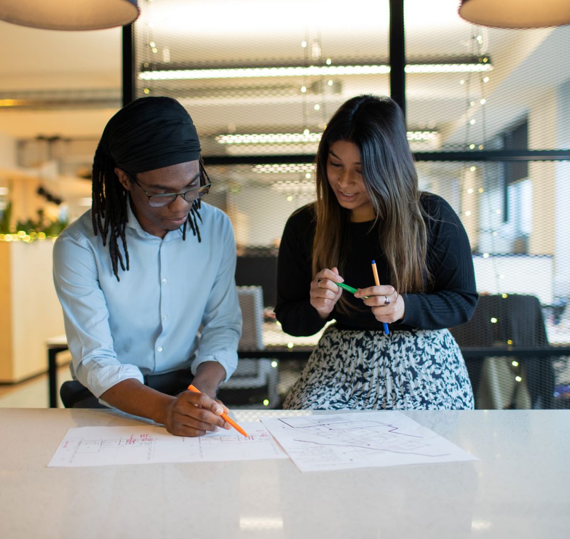 Two people looking at a drawing