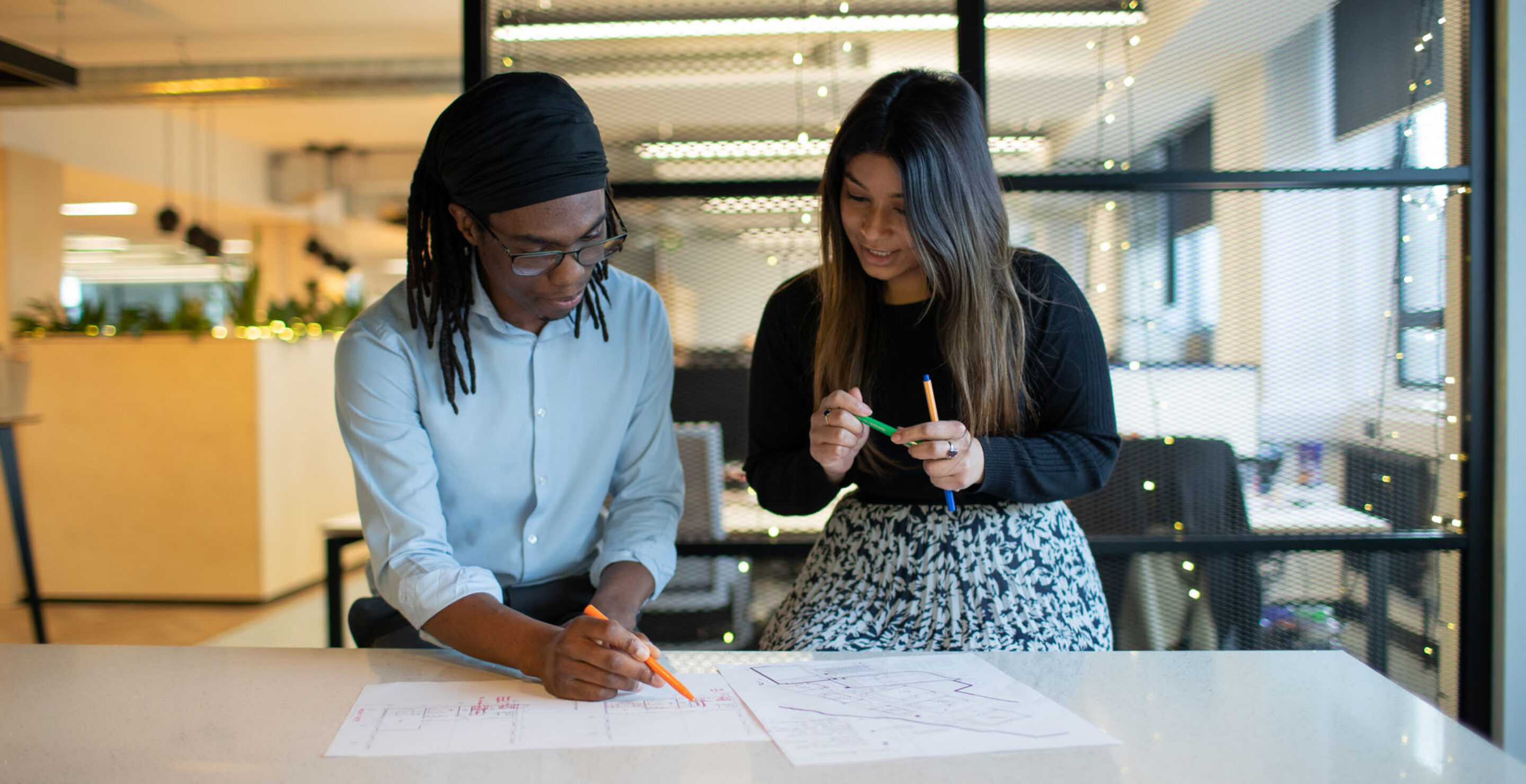 Two people looking at a drawing