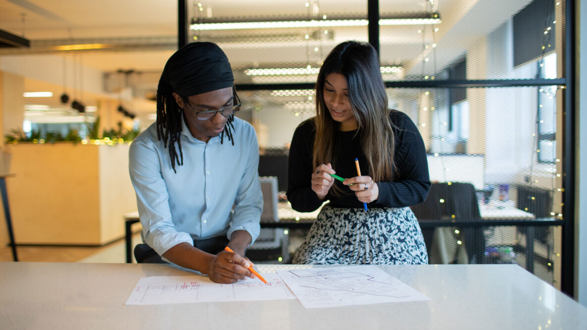 Two people looking at a drawing