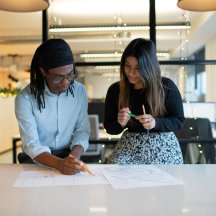 Two people looking at a drawing
